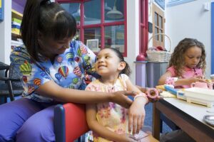 Picture of a nurse hugging a child patient