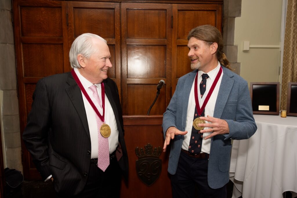 2 people both wearing medals