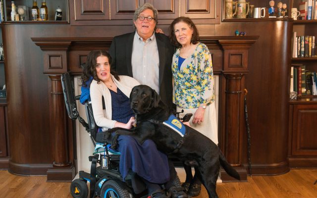 Margaret Hackett and her parents, Bill and Raynelle, and her service dog, Feivel.