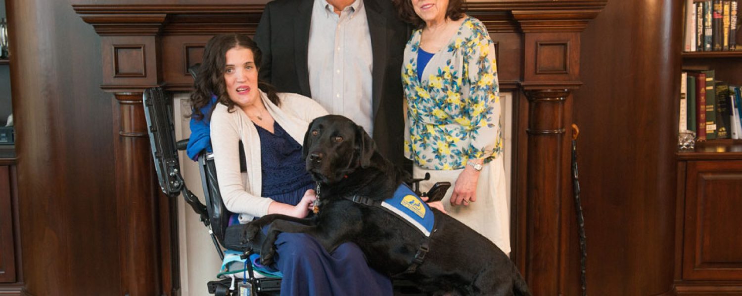 Margaret Hackett and her parents, Bill and Raynelle, and her service dog, Feivel.