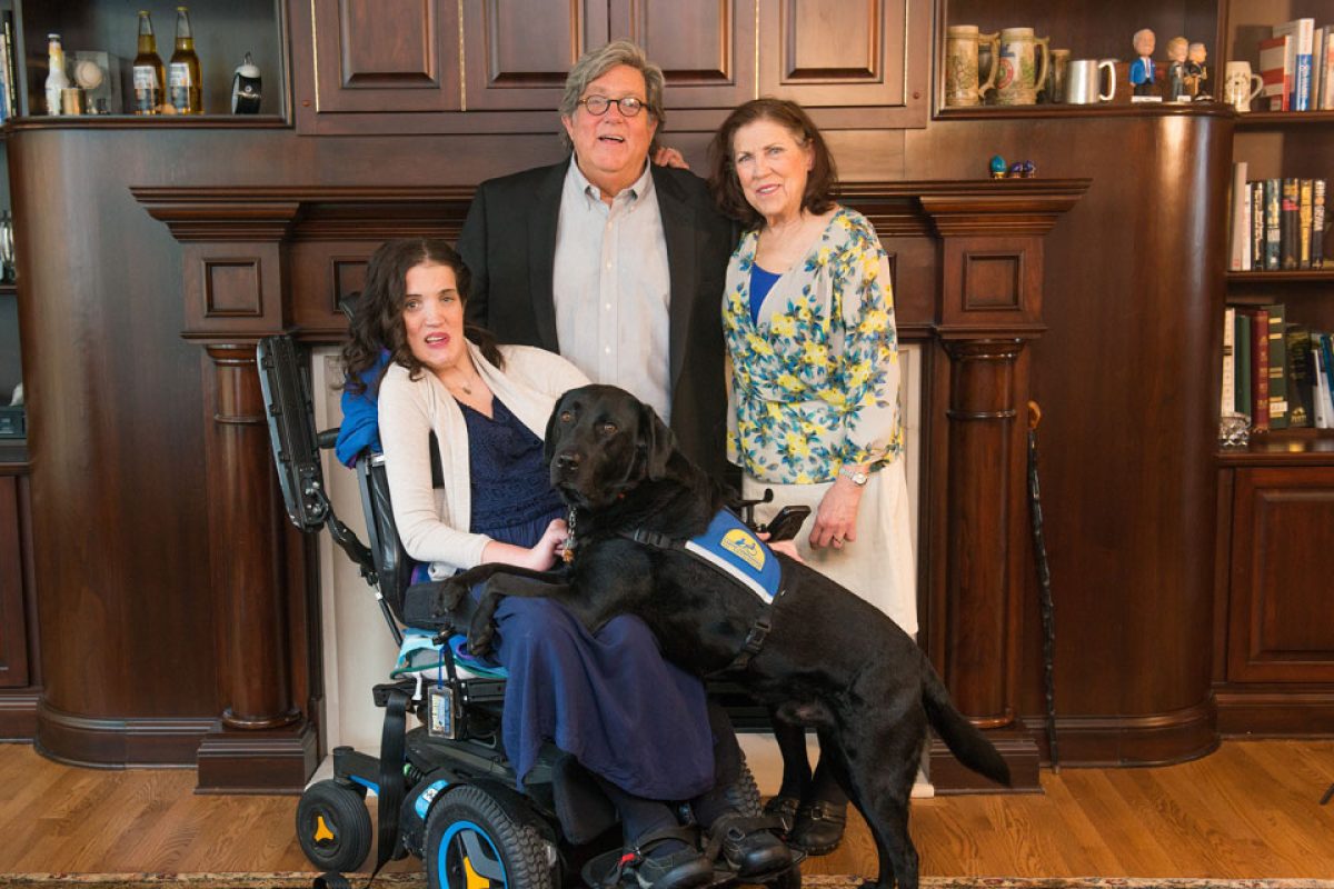 Margaret Hackett and her parents, Bill and Raynelle, and her service dog, Feivel.
